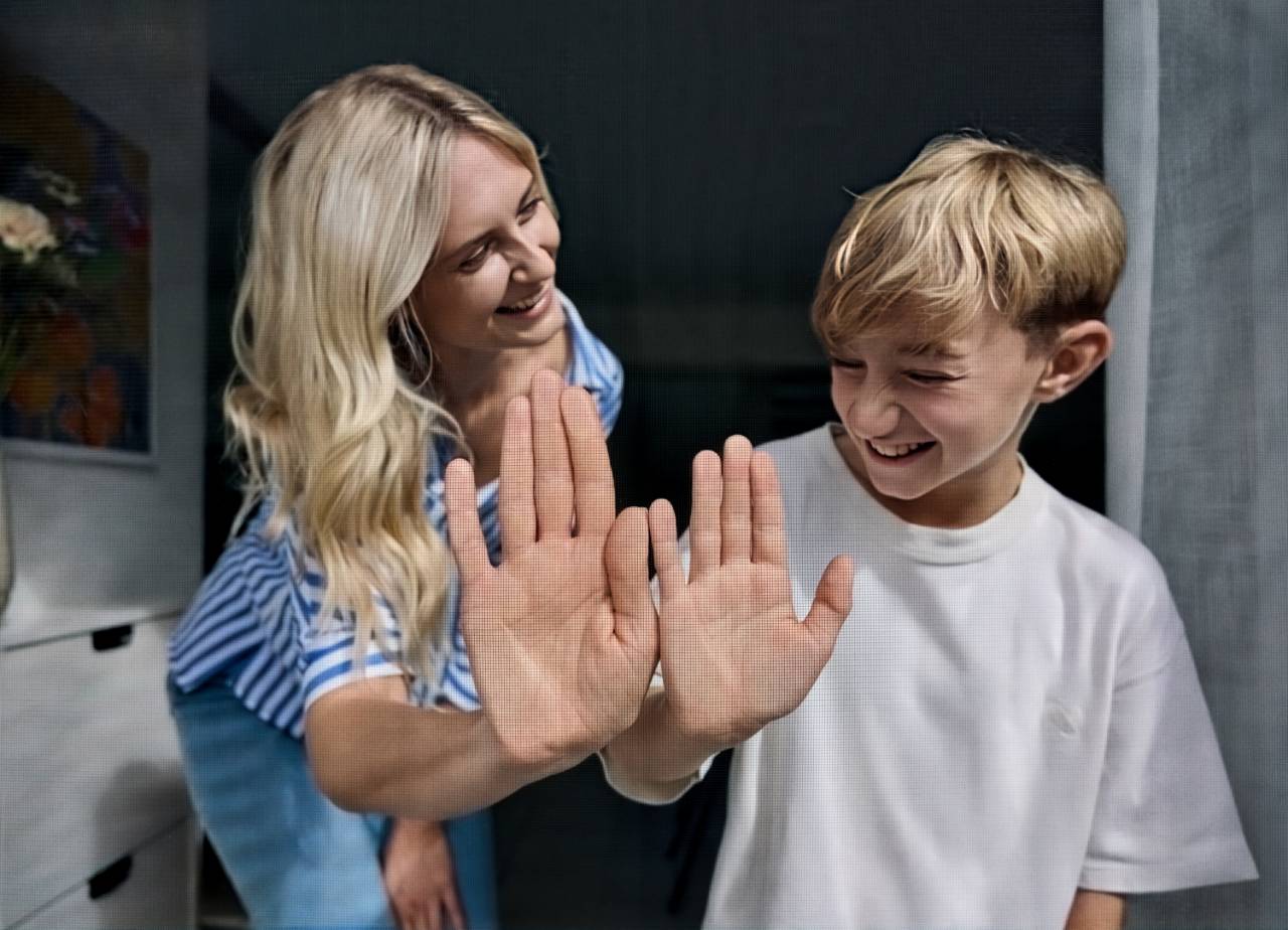 Zwei Personen berühren ein feinmaschiges, fast unsichbares Insektenschutz Gewebe von innen am Fenster